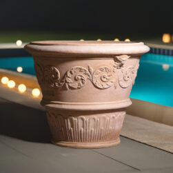 Pot decorated with spirals in terracotta, featuring a raised vine motif and satyr reliefs, handcrafted in Impruneta clay. Large capacity and frost-resistant.