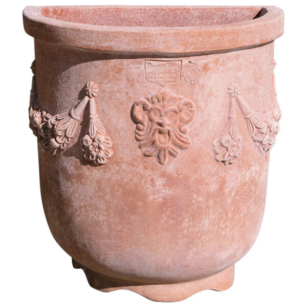 Frost-resistant terracotta wall planter with embossed decorations and festoons on the sides, ideal for gardens and indoor spaces.