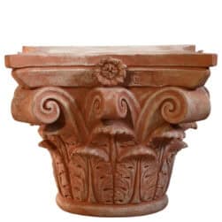 Corinthian capital in terracotta with carved acanthus leaves and lateral volutes