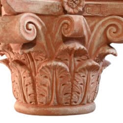 Corinthian capital in terracotta with carved acanthus leaves and lateral volutes