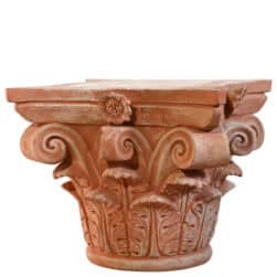 Corinthian capital in terracotta with carved acanthus leaves and lateral volutes