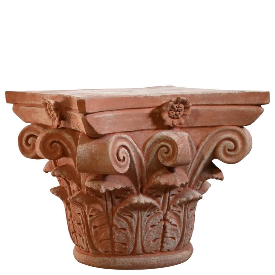 Corinthian capital in terracotta with carved acanthus leaves and lateral volutes