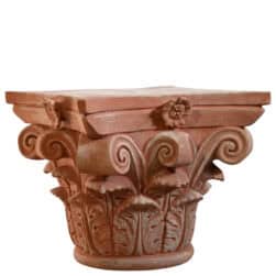 Corinthian capital in terracotta with carved acanthus leaves and lateral volutes