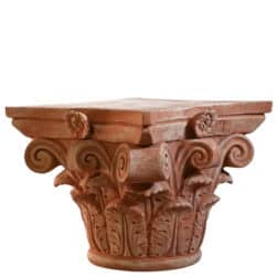 Corinthian capital in terracotta with carved acanthus leaves and lateral volutes