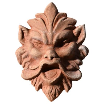 Terracotta mask relief depicting a demonic expressive face, symbolic architectural decoration