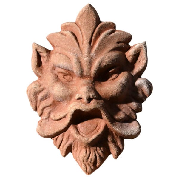 Terracotta mask relief depicting a demonic expressive face, symbolic architectural decoration