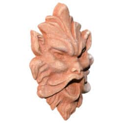 Terracotta mask relief depicting a demonic expressive face, symbolic architectural decoration