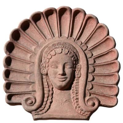 Terracotta Etruscan antefix with stylized female maenad head, ancient architectural decoration