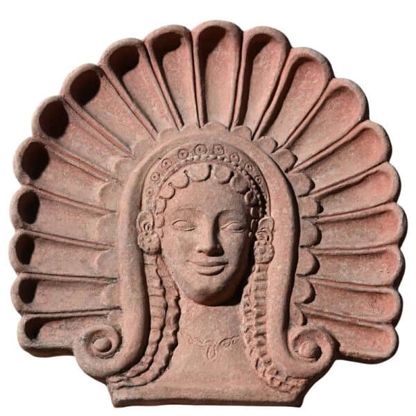 Terracotta Etruscan antefix with stylized female maenad head, ancient architectural decoration