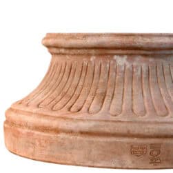 Fluted wall base in Impruneta terracotta, semicircular structure with vertical grooves and flat back for wall attachment.