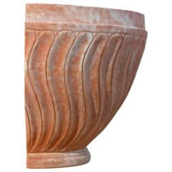 Terracotta wall planter with spiral-columned ribbed surface in half-moon shape