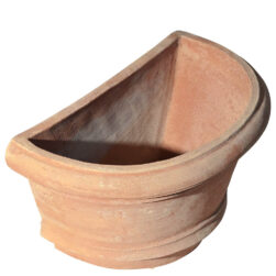 The Shallow wall pot with borders in terracotta, shaped like a half planter with decorative edges. Ideal for climbing plants. Perfect for terraces, gardens, and sidewalks.