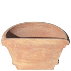 The Shallow wall pot with borders in terracotta, shaped like a half planter with decorative edges. Ideal for climbing plants. Perfect for terraces, gardens, and sidewalks.