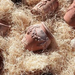 Small festooned jar in Impruneta terracotta with raised decorations and ornamental handles. Ideal as a decorative element or planter for flowers and greenery.