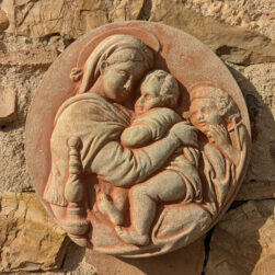 Still life photo of Handcrafted terracotta replica of Raphael's "Madonna della Seggiola," a symbol of devotion and Renaissance art, ideal for any environment and special occasion.