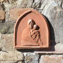 Bassorilievo Madonna nel Manto in terracotta artigianale. Raffinatezza e spiritualità. Con il bambino protetto nel manto, simboleggia protezione e serenità.