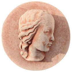 Terracotta panel with a high-relief face of Mary, featuring a serene profile and refined details, crafted from Impruneta clay.