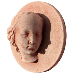 Terracotta panel with a high-relief face of Mary, featuring a serene profile and refined details, crafted from Impruneta clay.