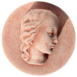 Terracotta panel with a high-relief face of Mary, featuring a serene profile and refined details, crafted from Impruneta clay.