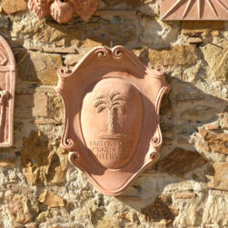 Decorative terracotta panel with a palm symbol, inspired by ancient academic seals. Handcrafted in Tuscany with a customizable cartouche for text or images.