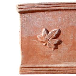 Rectangular terracotta planter box with three ivy leaves in relief on the front.