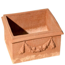 The Two Masks Flowerbox in terracotta, with garlands and grotesque masks, combines tradition and functionality, adding historical charm to gardens and terraces.